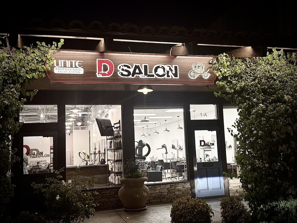 The illuminated D Salon storefront in Canyon Crest